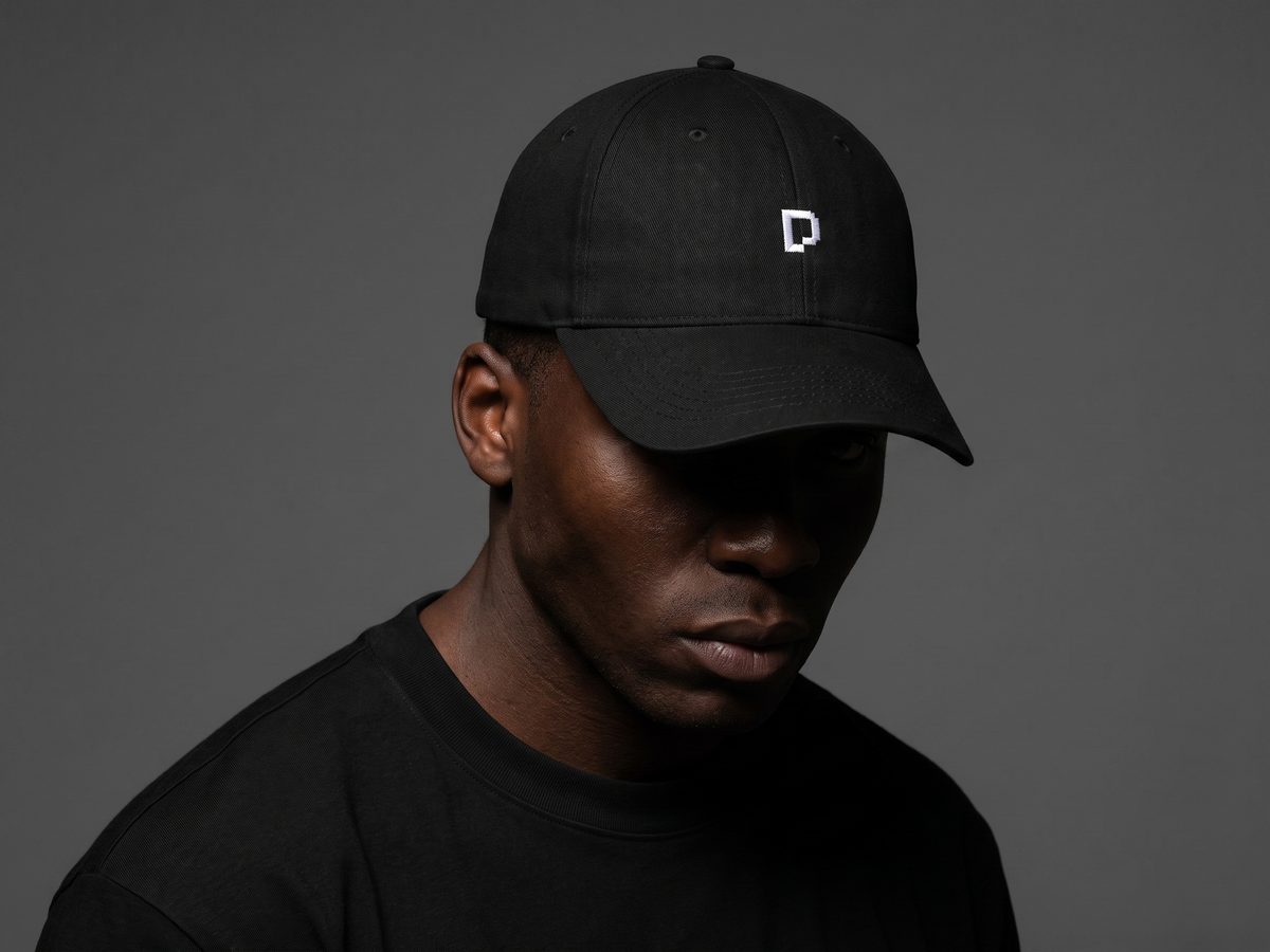 Chiptato — branded cap photographed in low key light