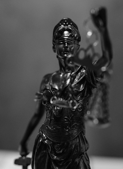 Bronze figure of Lady Justice raising the scales